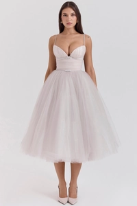 Detail of light pink tulle dress featuring spaghetti straps and a multi-layered mesh skirt