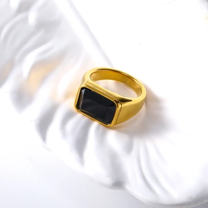 Detail view of a 18k gold minimalist ring with a large rectangular black gemstone inlay
