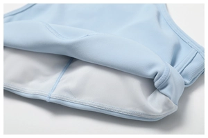 Détail du haut de yoga bleu clair avec doublure en maille blanche et coutures soignées