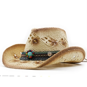 Detail of straw cowboy hat with ethnic beaded band, turquoise stone and frayed edges
