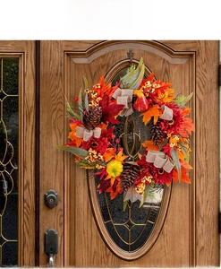 Artificial fall wreath with red sunflowers, pinecones, and pumpkins for front door decor