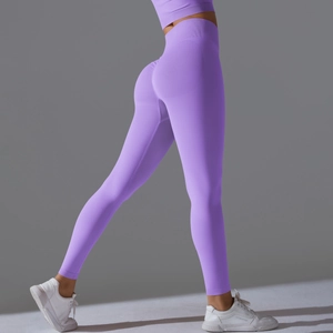 High-waisted seamless purple yoga leggings with peach lift effect for fitness and running