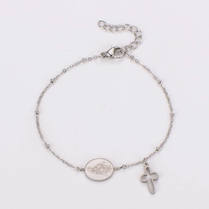 Detailed macro view of silver stainless steel chain with cross and religious coin charms