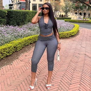 Women's 2-piece polka dot sportswear set featuring a halter top and slim leggings