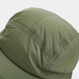 Detailed close-up of olive green ripstop fabric and parallel stitching on a five-panel cap