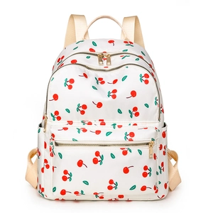 White casual backpack featuring red cherry prints and gold zippers on white background