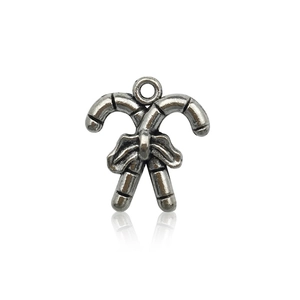 Detailed macro of antique silver alloy candy cane pendant with a festive bow for DIY jewelry