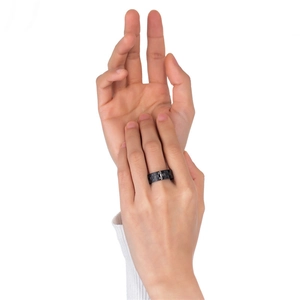 Fashionable gold and black checkerboard stainless steel ring worn on model's hand
