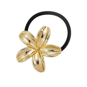 Detail of a metallic gold flower hair tie with an elastic band and mirror finish