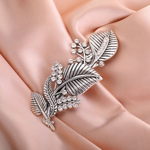 Luxury silver leaf hair clip with rhinestones for weddings on satin background
