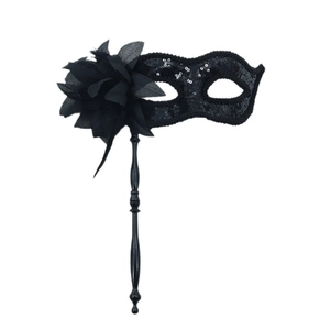 Elegant black masquerade mask with floral decoration and sequins on a handheld stick