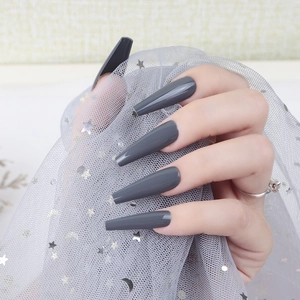 Detail of glossy dark grey extra-long coffin press-on nails with UV finish