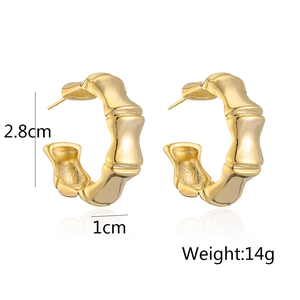 Detail view of gold C-shaped bamboo earrings with dimensions 2.8cm height and 14g weight