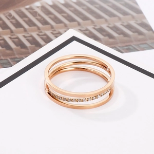 Detailed macro view of triple-layered rose gold titanium steel ring with micro-set zircons