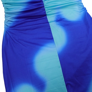 Close-up of blue tie-dye printed dress with ruched side details and smooth fabric texture