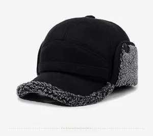 Detail of warm black trapper hat featuring gray faux fur lining and ear protection