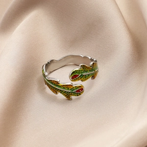 Detail of adjustable silver ring with colorful enamel leaves and animals on silk