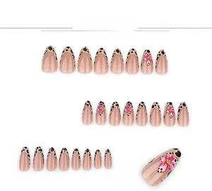 Detail of almond fake nails with French leopard print, 3D flowers and yellow rhinestones