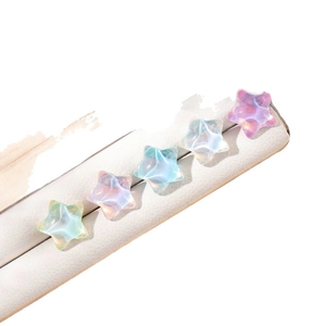 Iridized star-shaped titanium steel screw back earrings displayed on white leather stand