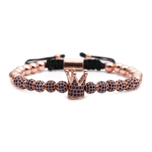 Close-up of rose gold crown bracelet with micro-pave blue cubic zirconia and black cord