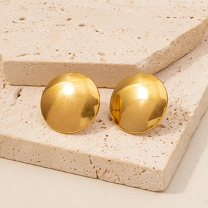Minimalist golden dome stud earrings in 304 stainless steel on a travertine stone