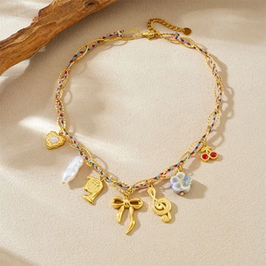 Vintage gold layered necklace featuring charms of pearls, flowers, and musical notes