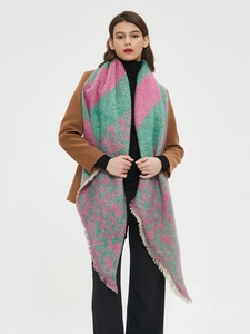Detail shot of the pink and green leopard print scarf texture and tassel edge