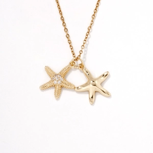 Elegant gold-tone necklace featuring double starfish pendants with crystal accents