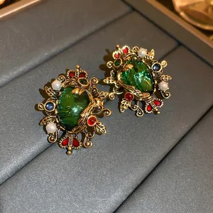 Vintage emerald crystal and pearl crown stud earrings in antique gold finish and retro style