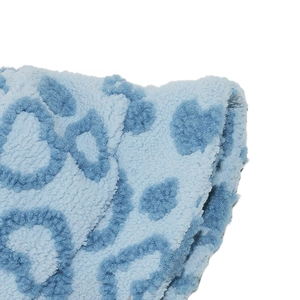 Detail of light blue faux fur bucket hat featuring dark blue heart leopard pattern