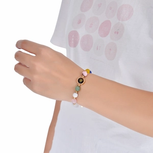 Detailed shot of multi-color beaded bracelet with a black and gold Cancer zodiac pendant