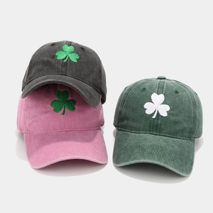 Detailed view of shamrock embroidery on washed cotton baseball caps in multiple colors