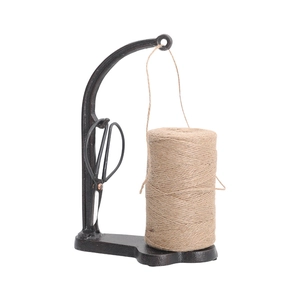 Vintage style cast iron twine holder set with scissors and jute rope on white background