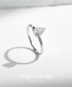 Detailed close-up of a pear-shaped moissanite stone set in a minimalist S925 silver ring