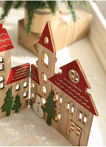 Macro detail of wooden Christmas fence with snowflake house and pine tree decor