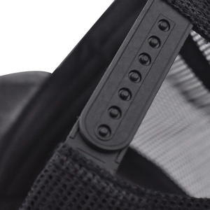 Detailed macro view of the adjustable snapback closure and mesh panel on a black baseball cap