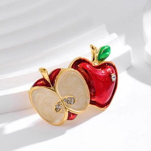 Creative enamel red apple brooch with crystal rhinestones on a white background