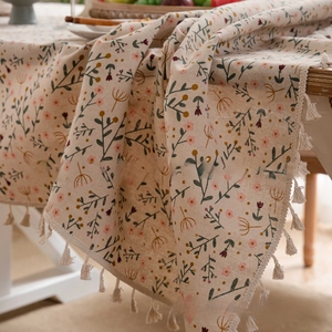Close-up of vintage floral cotton linen tablecloth with elegant cotton tassel edge details