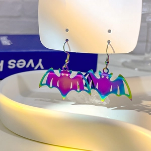 Detailed view of iridescent metal bat earrings with colorful gradient finish and hooks