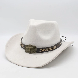 Detail of white suede cowboy hat featuring brown leather band and bull head metal buckle