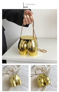 Detail shot of mini gold female torso handbag with reflective mirror finish and chain