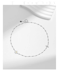 Detail of S925 silver choker with white daisy charm and sparkling diamond cross pendant