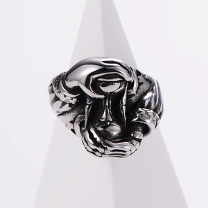 Gothic style silver-black stainless steel ring displayed on a white conical stand
