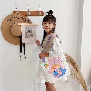 Detailed shot of cartoon girl pattern on canvas tote bag with purple shoulder strap