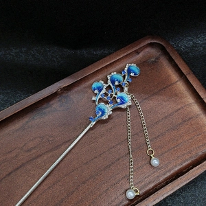 Vintage silver hair pin with blue enamel phoenix and pearl tassels on dark wood