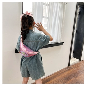 Rear view of a girl wearing a pink sequin shell crossbody bag with adjustable strap