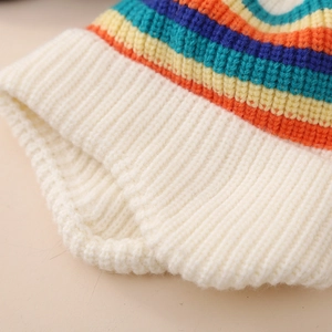 Cozy winter baby knit hat featuring colorful rainbow stripes and white ribbed texture