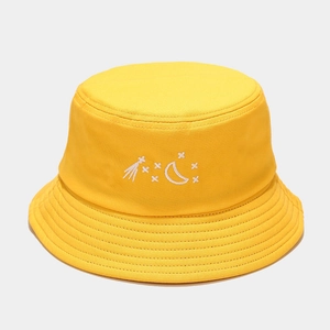 Detail of yellow cotton bucket hat featuring white moon and star embroidery on front