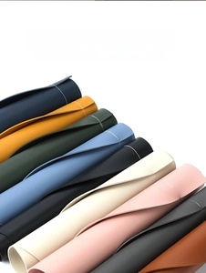 Close-up of colorful waterproof PU leather placemats with fine litchi texture