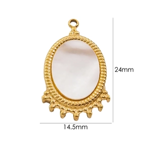 Macro shot of gold oval pendant with white shell inlay and twisted rope edges